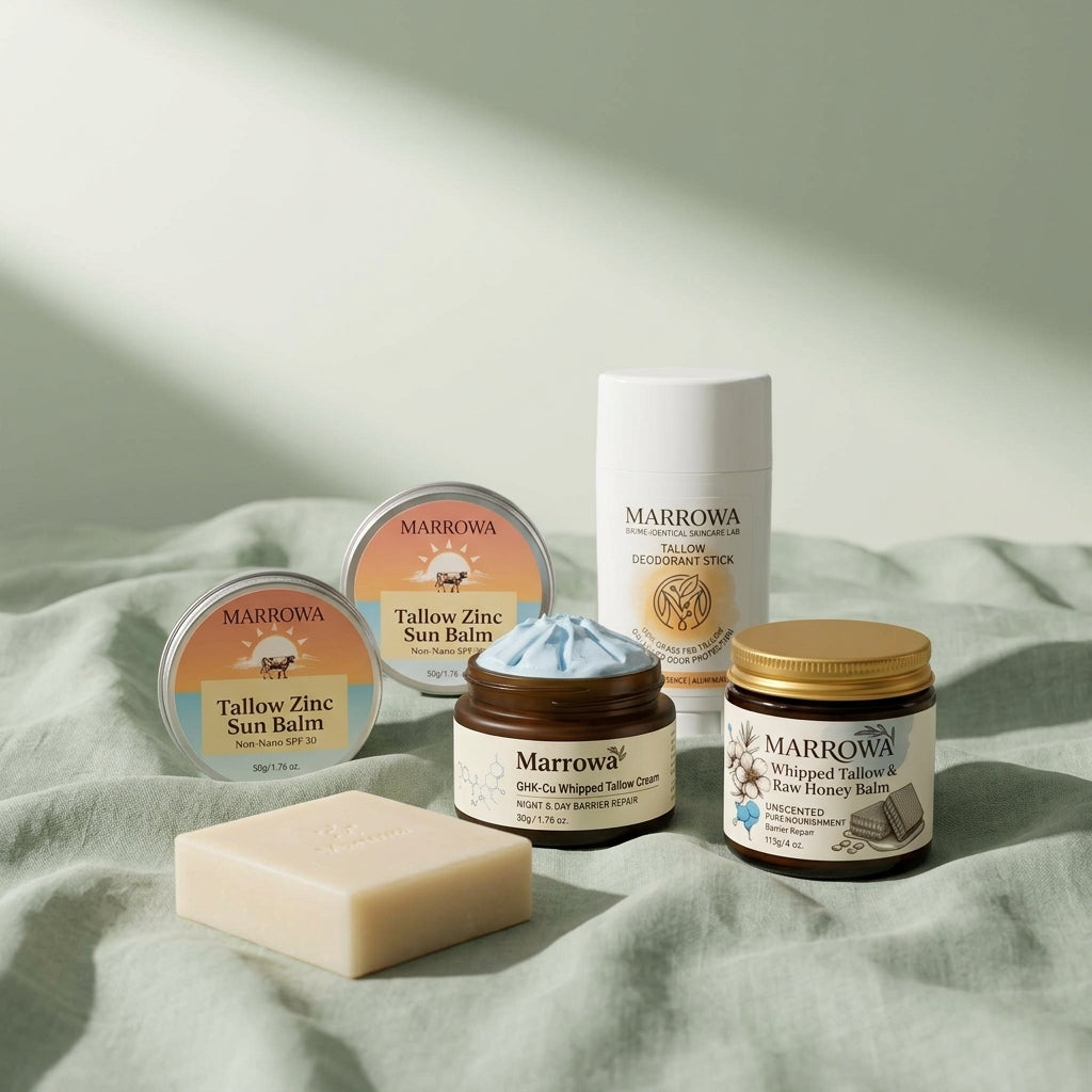 Marrowa tallow balm, copper peptide cream, sun balm, cleansing bar and deodorant arranged on pale linen